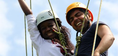 Students celebrate a successful climb at the Ivey Spencer Ropes Course in London, Ontario.